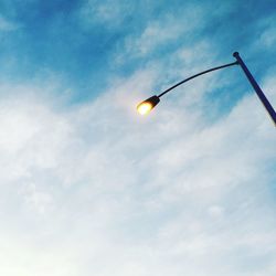 Low angle view of street light against cloudy sky
