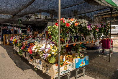 Multi colored flower pots for sale at market stall