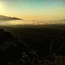 Scenic view of silhouette mountains against sky at sunset