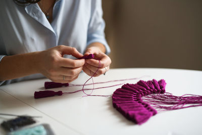 Craftswoman makes brushes from threads. concept creativity and handwork, toning in real interior