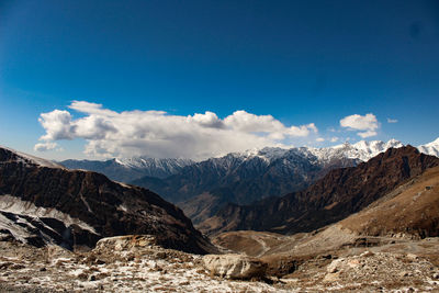 Scenic view of snowcapped mountains against blue sky