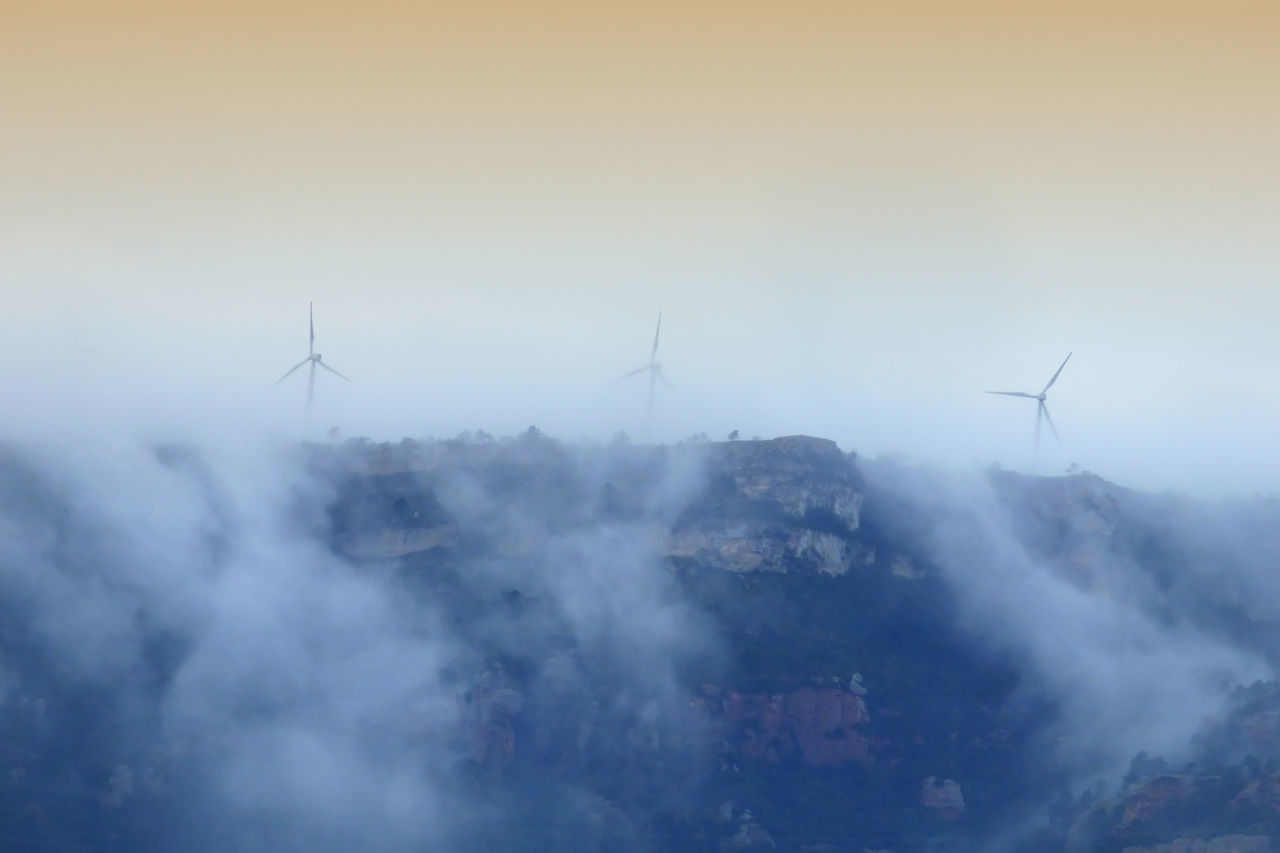 AERIAL VIEW OF WIND TURBINES AGAINST SKY