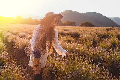 Full length of woman standing on field