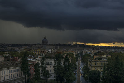 View of cityscape against storm clouds