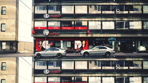 Cars on street against building in city