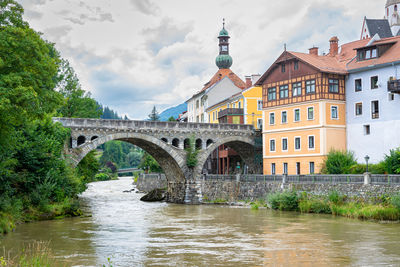 View of the town of murau in state steiermark, austria. scenic arch bridge over river mur.