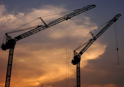 Low angle view of crane against sky at sunset