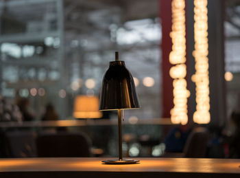 Close-up of lamp on table in restaurant