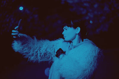 Portrait of man holding blue water