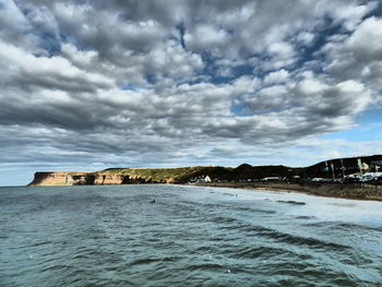 View of calm sea against cloudy sky