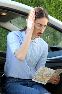 Full length of woman sitting in car