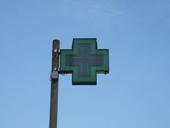 Low angle view of information sign against clear sky