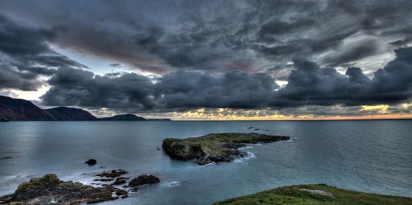 Scenic view of sea against dramatic sky