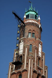 Low angle view of bell tower against blue sky