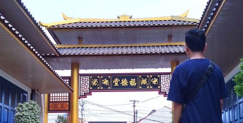 Rear view of man on temple against building