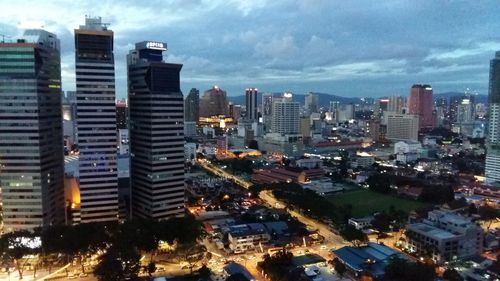 Aerial view of illuminated cityscape against sky at night