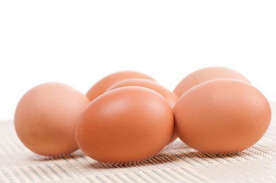 Close-up of eggs against white background