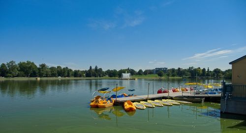 Boat moored in lake against sky