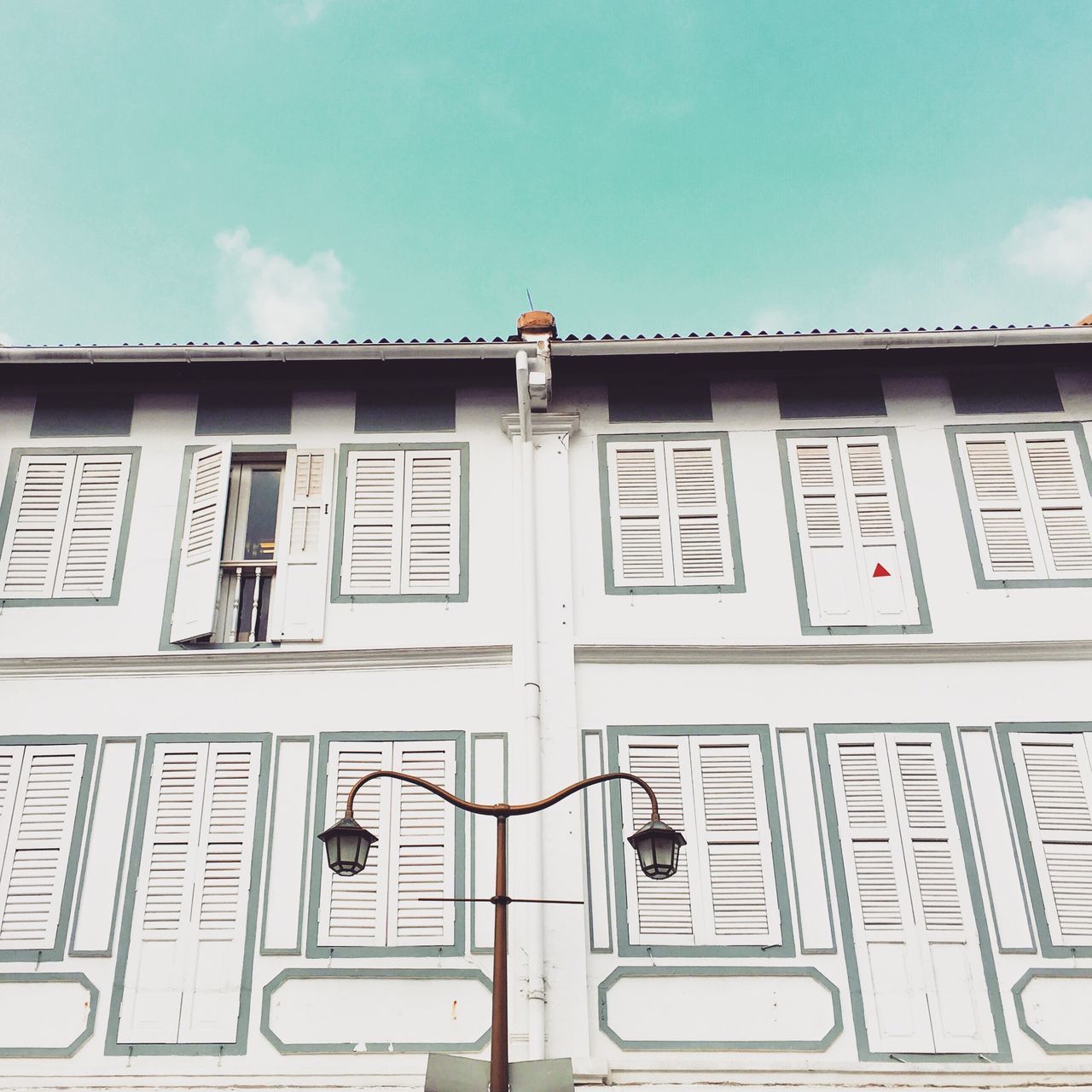 architecture, building exterior, built structure, window, low angle view, building, sky, facade, balcony, day, residential building, outdoors, residential structure, city, railing, no people, art and craft, exterior, arch, art