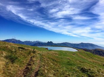 Scenic view of landscape against cloudy sky