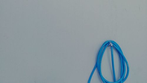 High angle view of blue paint on table against white background