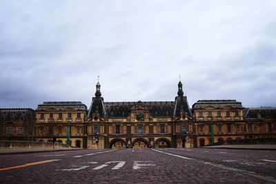 View of building in city against cloudy sky