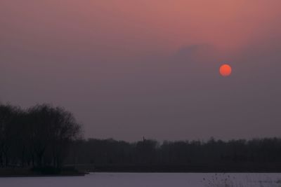 Scenic view of river at sunset