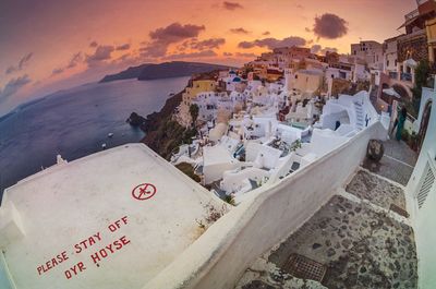 Fish-eye view of houses in oia at santorini by aegean sea during sunset