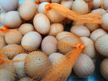 Close-up of eggs in nets for sale at store