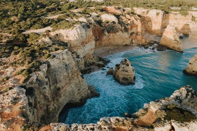 High angle view of rocks on sea shore