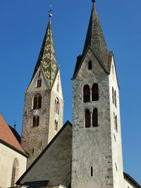 Low angle view of historic building against clear blue sky