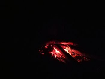 Close-up of illuminated bonfire against sky at night