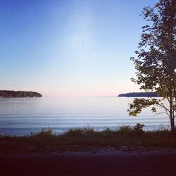 Scenic view of sea against clear sky at sunset