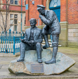 Statue of man sitting in city