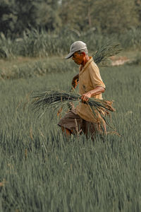 Man working in basket on field