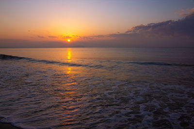 Scenic view of sea against romantic sky at sunset