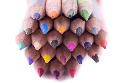 High angle view of multi colored pencils on white background