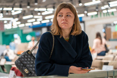 Portrait of young woman using laptop while sitting on table