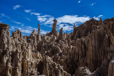 Low angle view of rock formation against sky