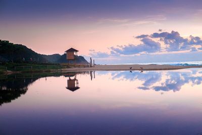 Scenic view of lake against sky during sunset