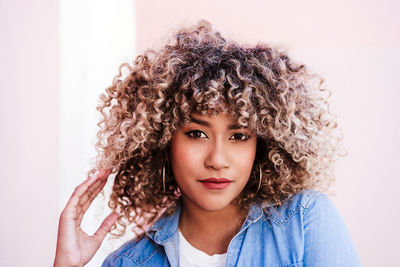 Portrait of young woman against white background