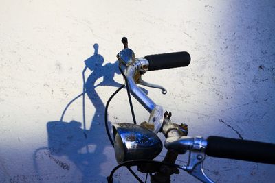 Bicycle parked against wall in city