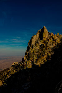 Close-up of rock formation against blue sky
