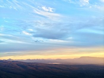 Scenic view of mountains against sky at sunset
