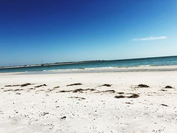 Scenic view of sea against clear blue sky