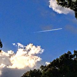 Low angle view of vapor trails in sky