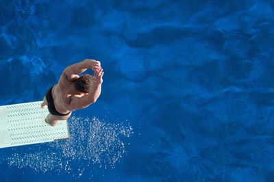 Directly above shot of man jumping in pool