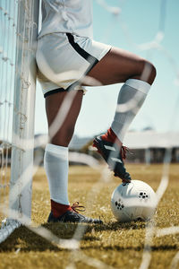 Low section of woman playing soccer