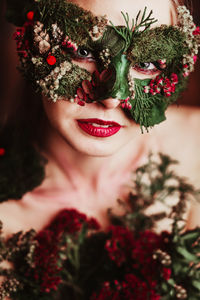Portrait of woman with flower mask looking away
