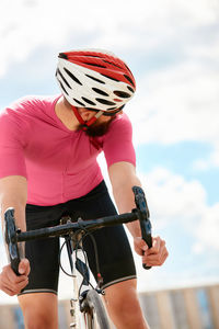 Man looking behind while sitting on bicycle